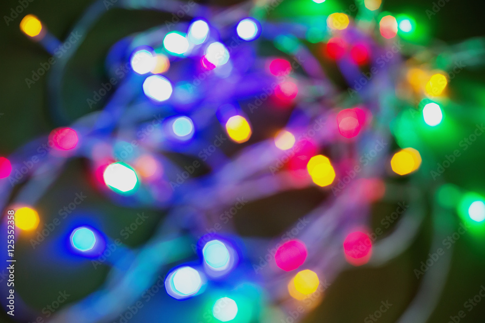 Naklejka premium Blur bokeh from Christmas lights with wooden background