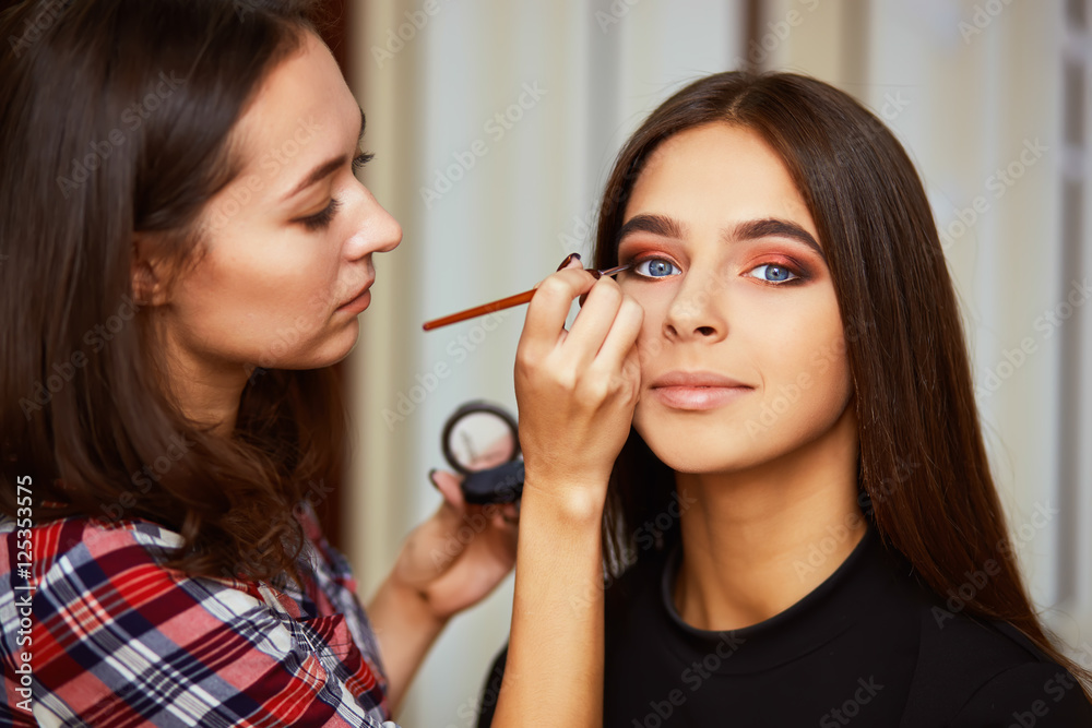 Make-up artist applying liquid eyeliner with brush, close up.
Make-up artist applying liquid eyeliner with brush, close up.