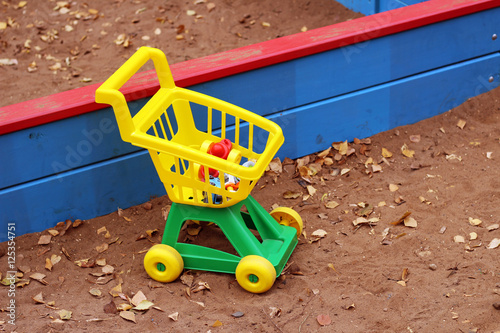 yellow shopping cart toy, outdoor
