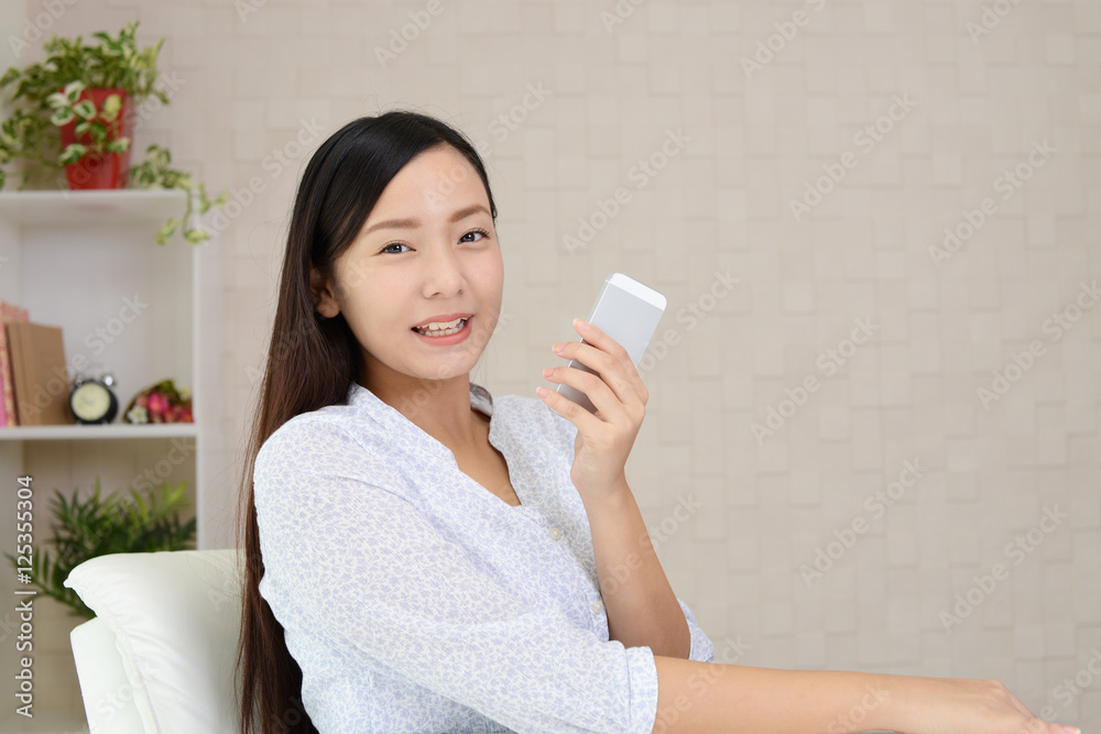 スマートフォンを持つ笑顔の女性