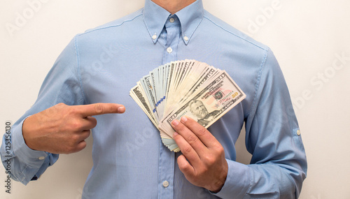 man holding a fan of the American currency 