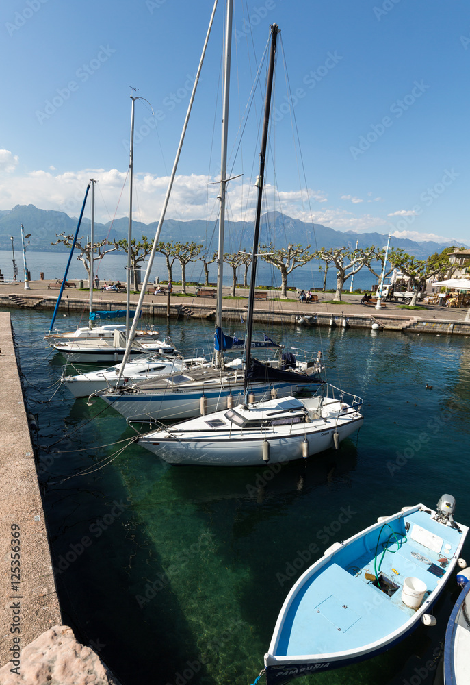 Fishing boats in the small harbor of Torri del Benaco. Garda Lake. Italy Fishing boats in the small harbor of Torri del Benaco. Garda Lake. Italy