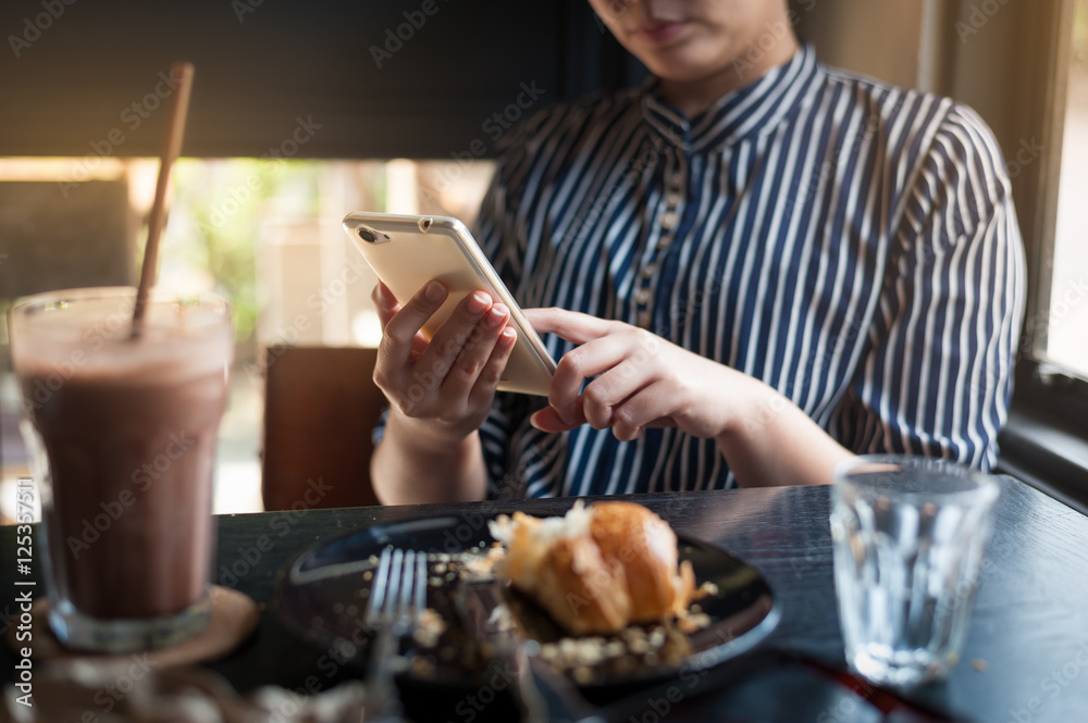 Woman using phone in cafe Woman using phone in cafe