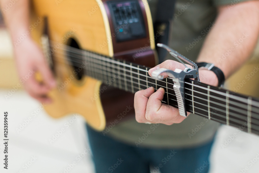 Man guitar player on acoustic guitar