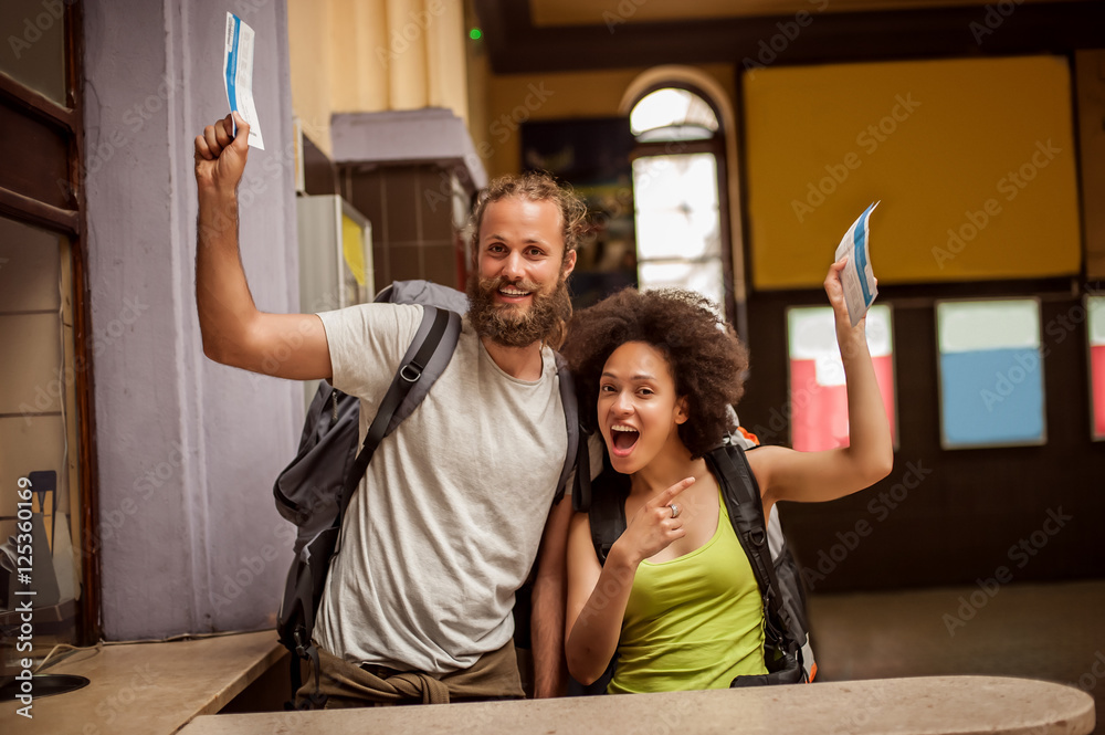 Φωτογραφία Very happy and euphoric couple of backpacker tourists show purchased tickets for