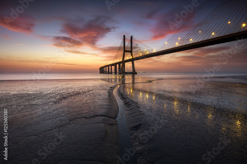 Beautifull sunrise over the Vasco da Gama bridge at Lisbon © Henrique Silva