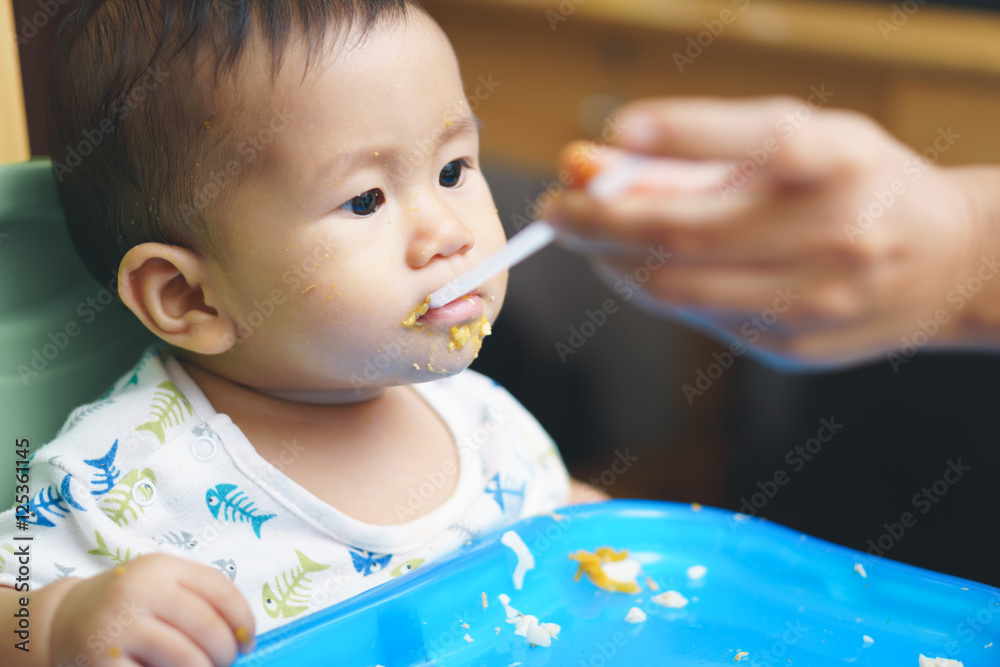 Asian baby drinking through straw Asian baby drinking through straw