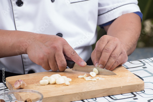Chef is cutting garlic /