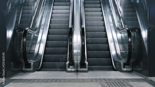 Close-up shot of empty moving staircase running up and down. Modern escalator stairs, which moves indoor.