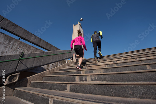 young couple jogging on steps