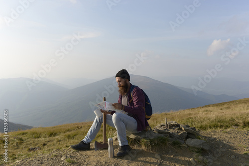 bearded man with ax on mountain