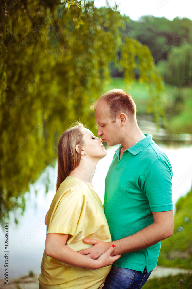 Beautiful pregnant woman with her husband outside Beautiful pregnant woman with her husband outside