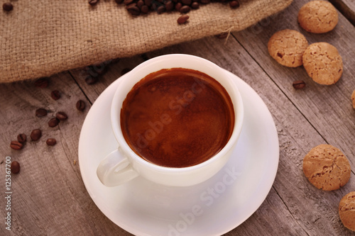 Cup of coffee on wooden surface 