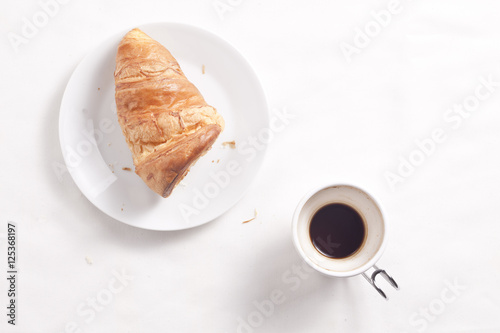 Coffee cup and croissant.