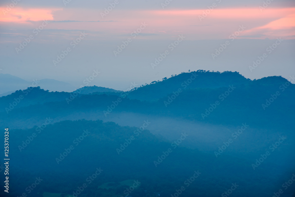 Light of sunset with mountains background in thailand
