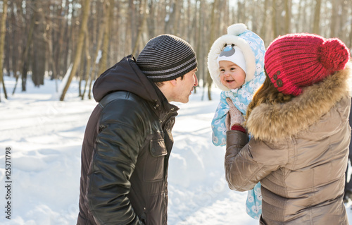 Happy family - Mother, father and child boy on a winter walk.