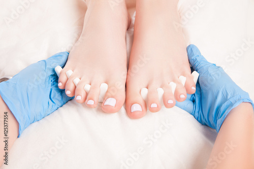 Cosmetic specialist making pedicure photo