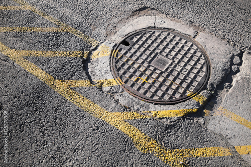 Sewer manhole cover with yellow lines