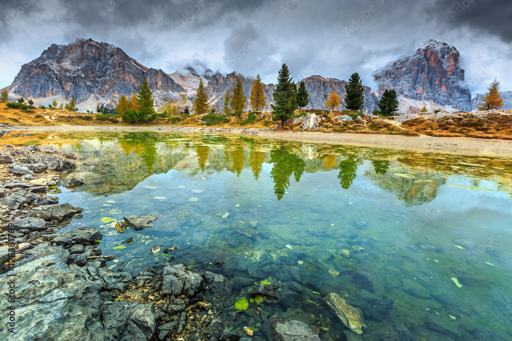 Wonderful alpine lake with misty peaks in background,Dolomites,Italy