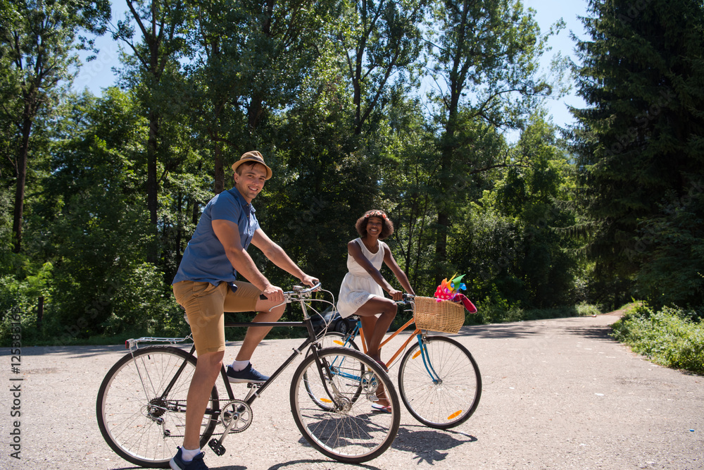 Young multiethnic couple having a bike ride in nature Young multiethnic couple having a bike ride in nature