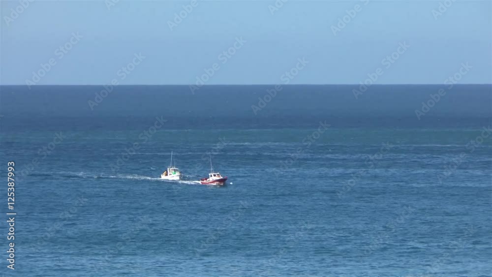 Fisher boat get towed in from the open sea in the harbor after a broken engine. Fisher boat get towed in from the open sea in the harbor after a broken engine.