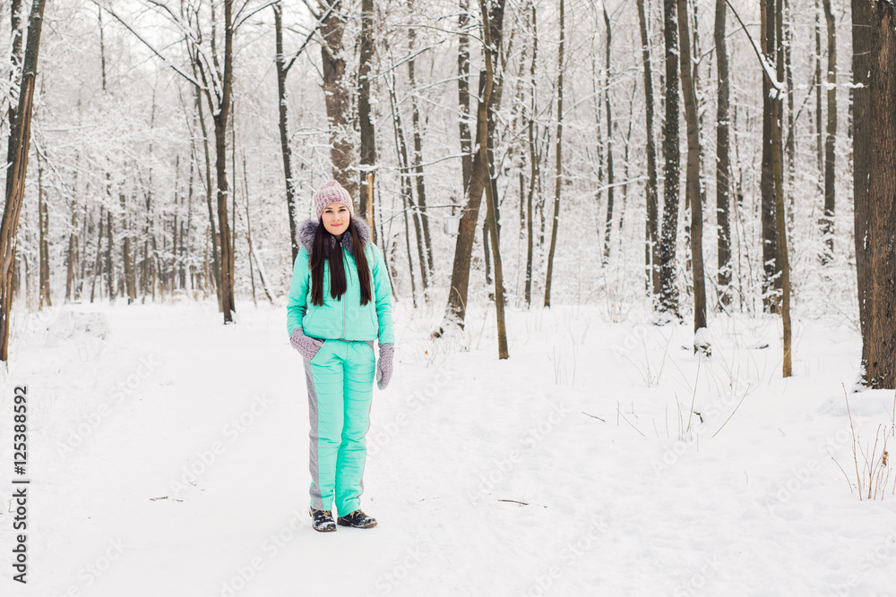 Beautiful young girl in a white winter forest