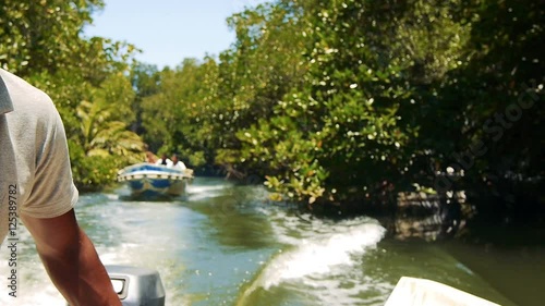 Indian man ride a boat on Kalu Ganga river in Sri Lanka