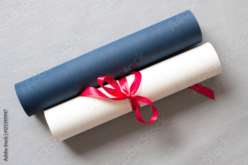 University diploma with case, red bow, top view