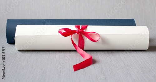 University diploma with case, red bow