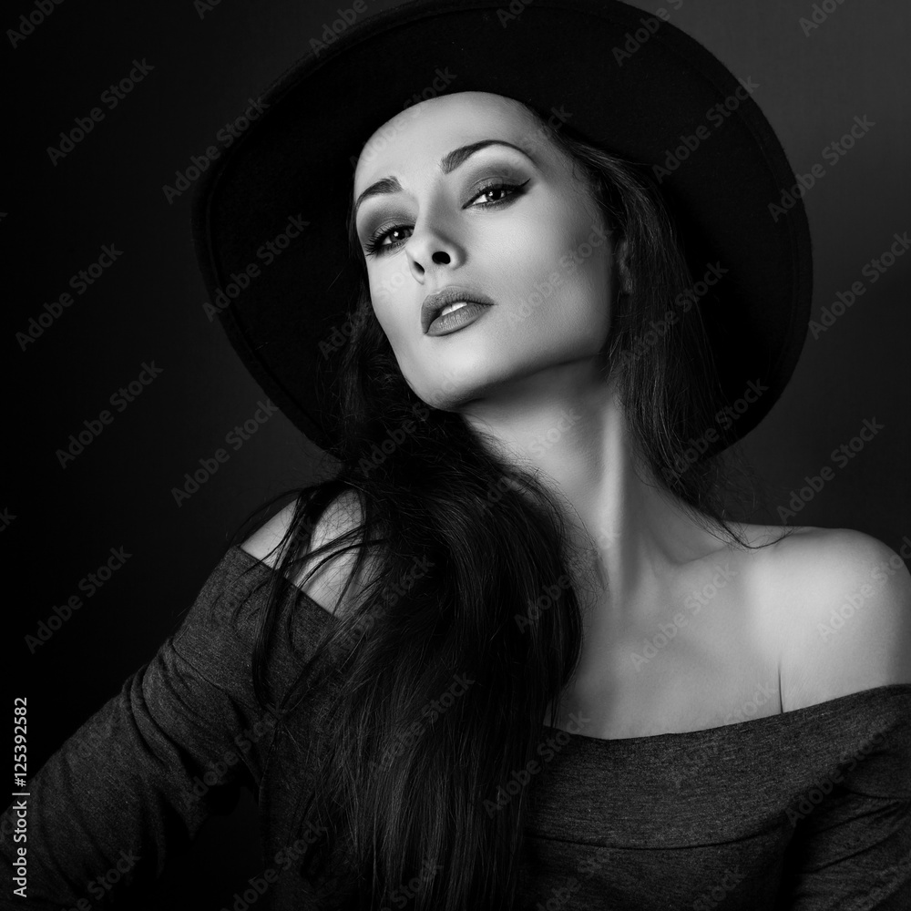 Sexy elegant makeup woman in fashion hat posing on dark shadow b Sexy elegant makeup woman in fashion hat posing on dark shadow b