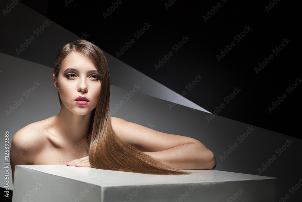 Fototapeta premium Close-up of beautiful young woman with shining hair
