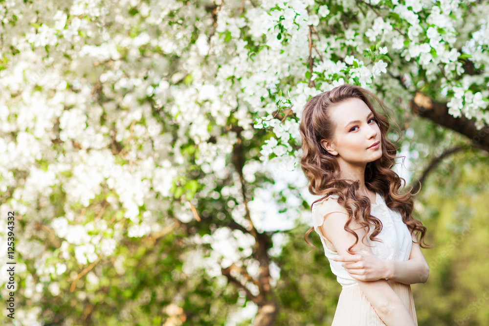 Beautiful woman posing near apple-tree in blossom Beautiful woman posing near apple-tree in blossom