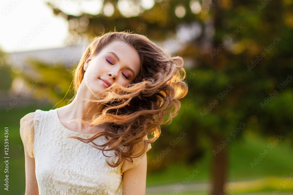 Girl at sunset with flying hair Girl at sunset with flying hair