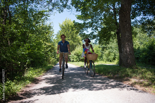Fototapeta Naklejka Na Ścianę i Meble -  Young multiethnic couple having a bike ride in nature