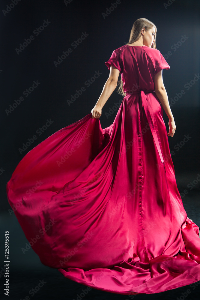 Back view of young blonde woman in bright pink dress Back view of young blonde woman in bright pink dress