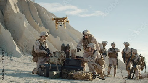 Soldiers are Using Drone for Scouting During Military Operation in the Desert. Slow Motion.