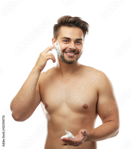 Young man applying shaving ...