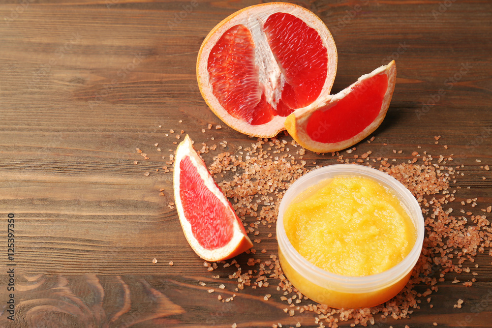 Body scrub and grapefruit on wooden background Body scrub and grapefruit on wooden background