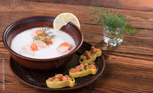 Fish soup with salmon, cream, vegetables and herbs photo