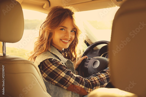 Young female driver in car ...
