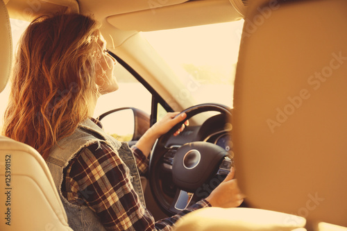 Young female driver in car ...