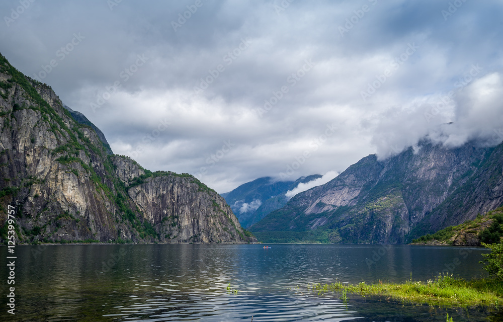 Scenic Norway fjord landscape and kayak on the water. Eidfjord.