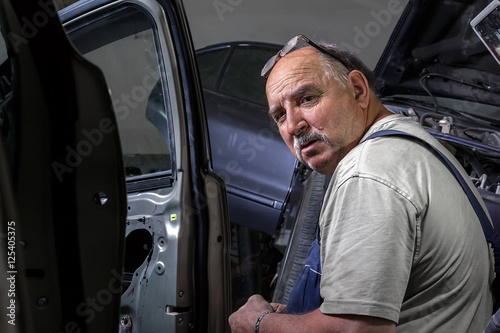 portrait of an elderly mechanic