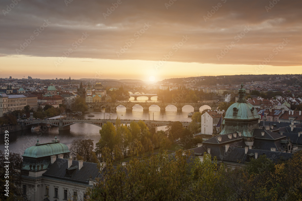 Sunset landscape view to Charles bridge on Vltava river in Prague Czech republic in fall.