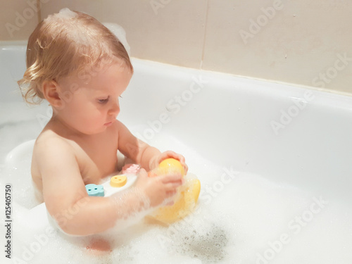 little 1,5 year-old baby boy playing in bath