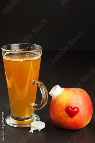 Healthy fresh apple juice drink on wooden background. Domestic production of apple juice for breakfast. 