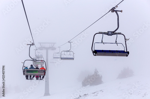 ski lift chairs in fog on ski resort Kopaonik, Serbia