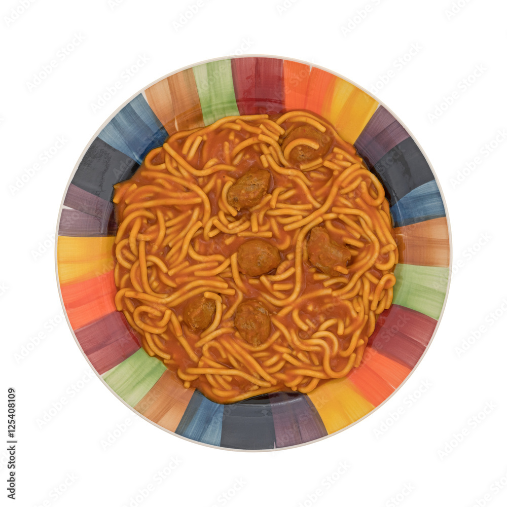 Colorful plate of spaghetti and meatballs on a white background top view.
