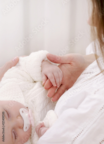 close up soft image of cute sleeping newborn baby with mother