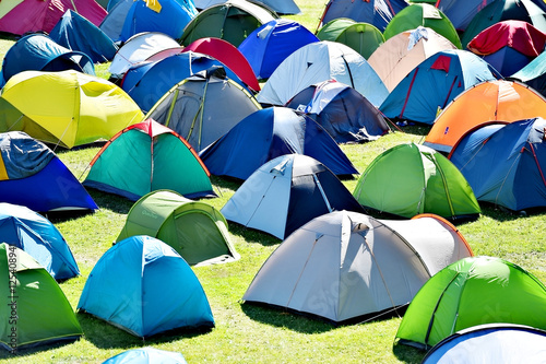 Lots of colorful tents on a meadow